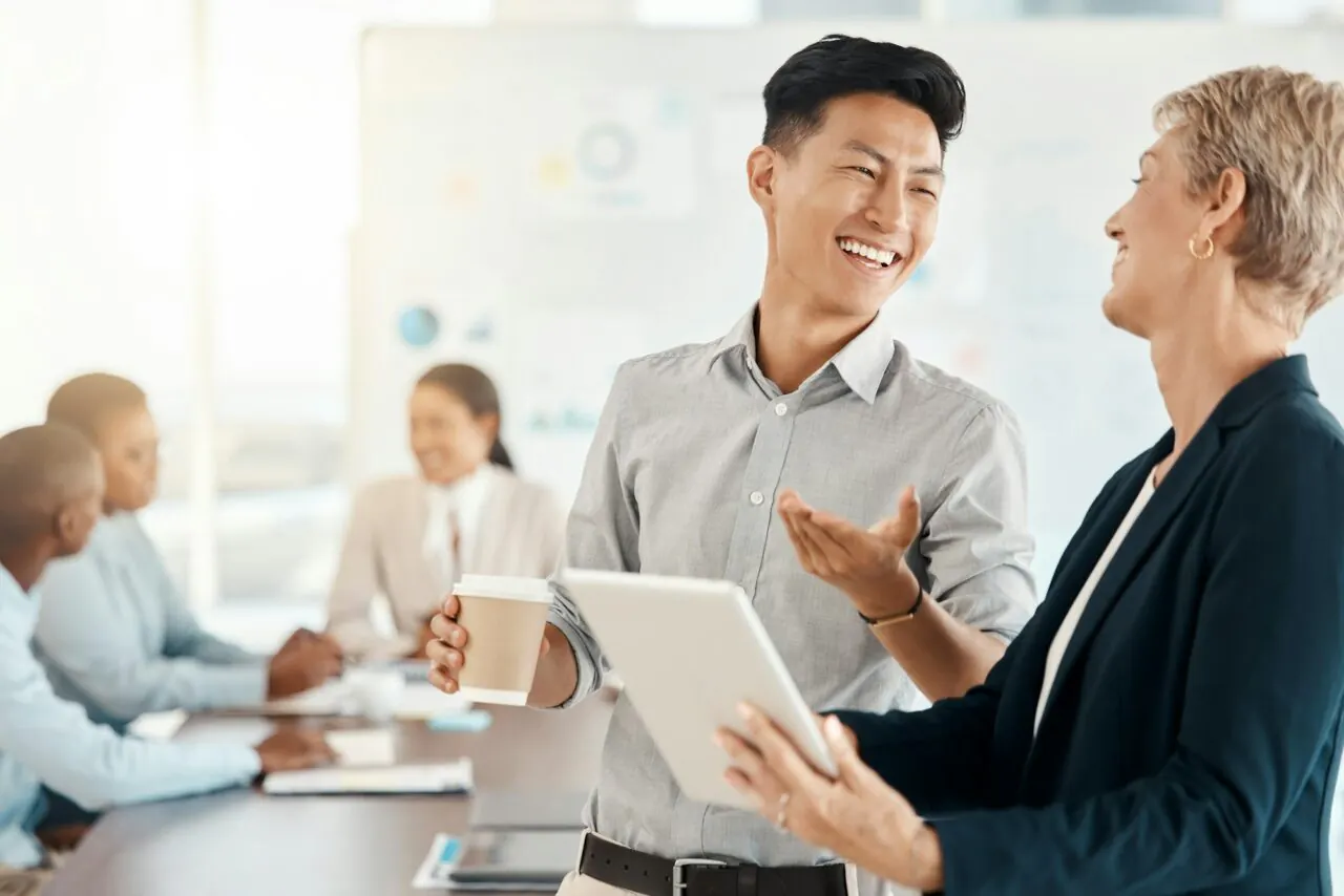 meeting woman and man with tablet happy conversation at creative marketing agency office