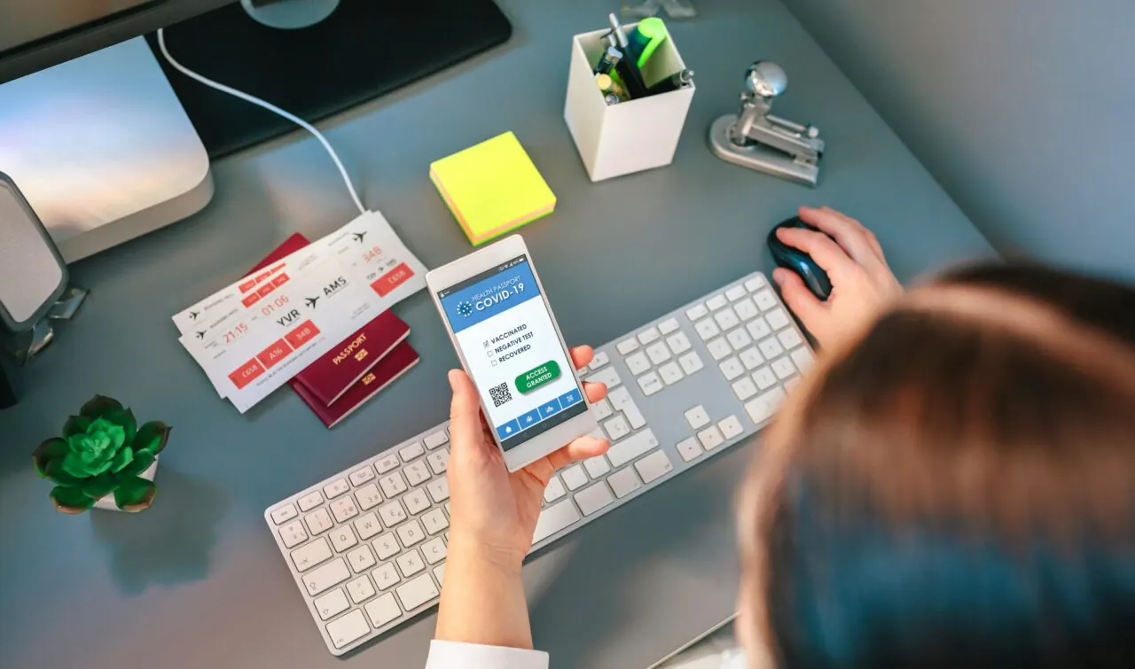 woman in a travel agency booking a trip looking at the covid passport